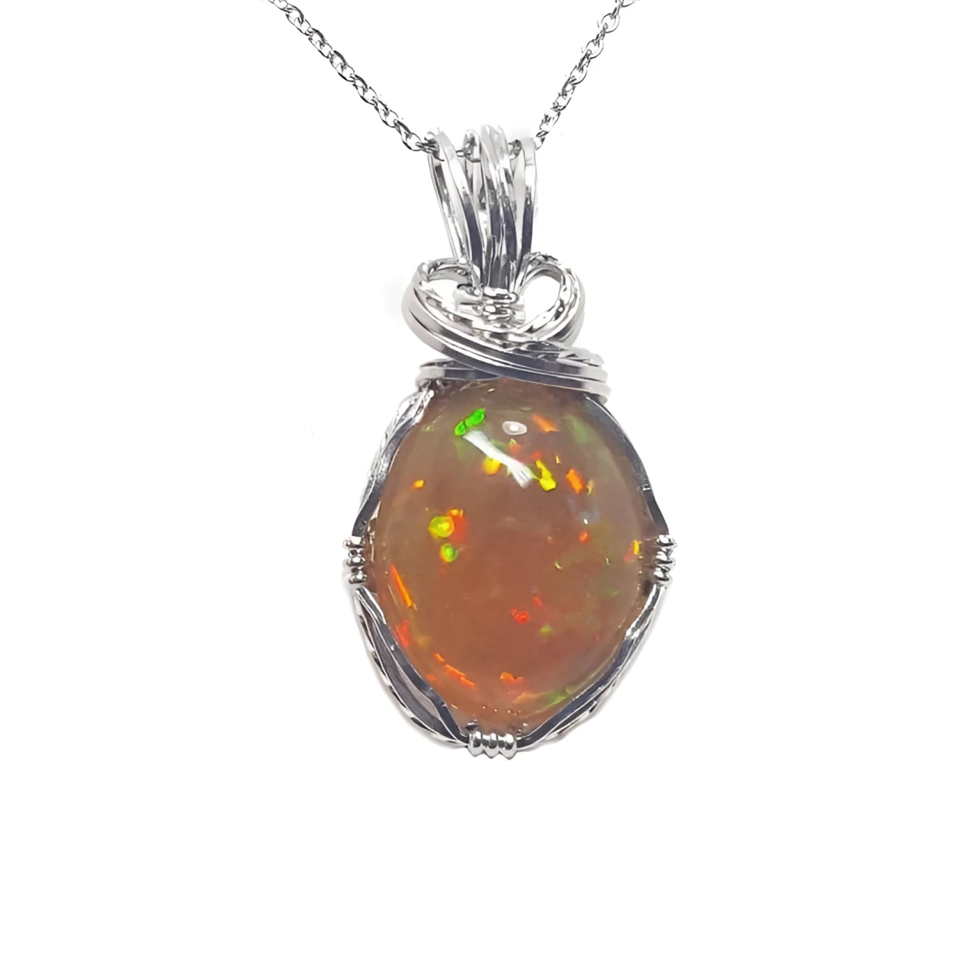 Oval Ethiopian opal pendant with vibrant play of colors and brown pinpoint fire, set in handcrafted silver wire wrap.
