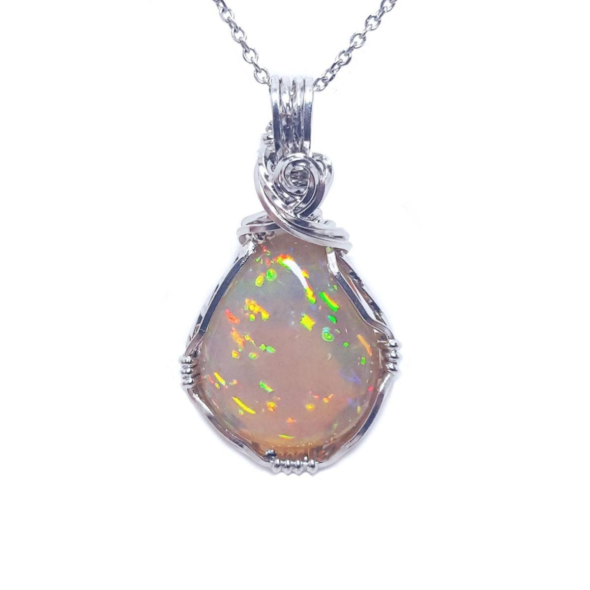 A wrap silver opal pendant necklace on a topside view position.