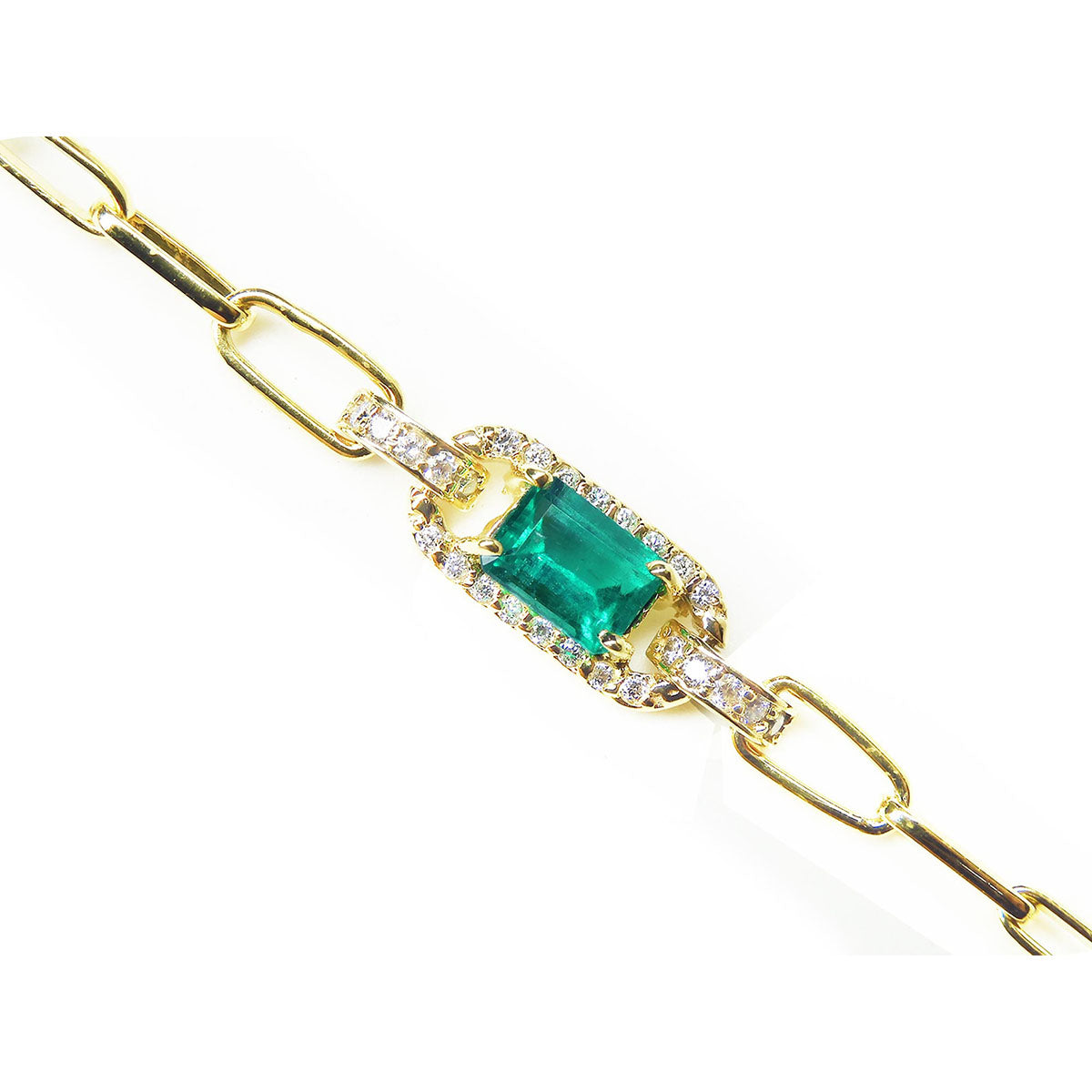 Gold paperclip bracelet with a square emerald on a topside position view.