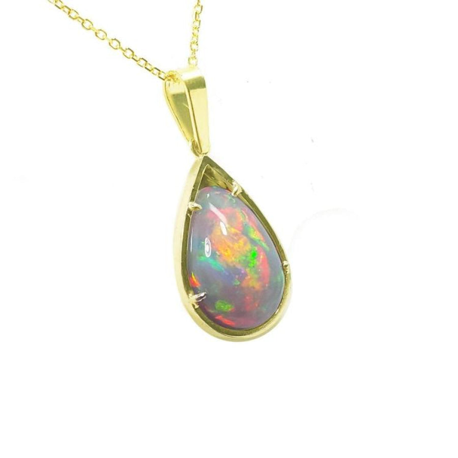 Pear-shaped Ethiopian Welo opal pendant with red-orange fire and rainbow colors, prong set in 14K yellow gold.