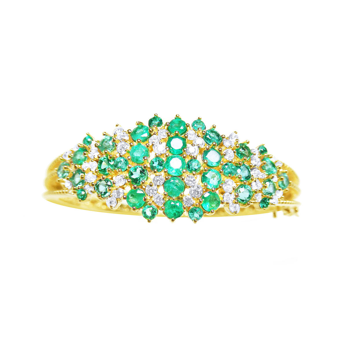topside view of a gold bangle bracelet with natura emeralds and diamonds.