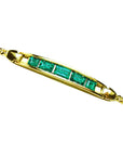 Gold bracelet with five natural colombian emeralds high quality on a topside vie position.