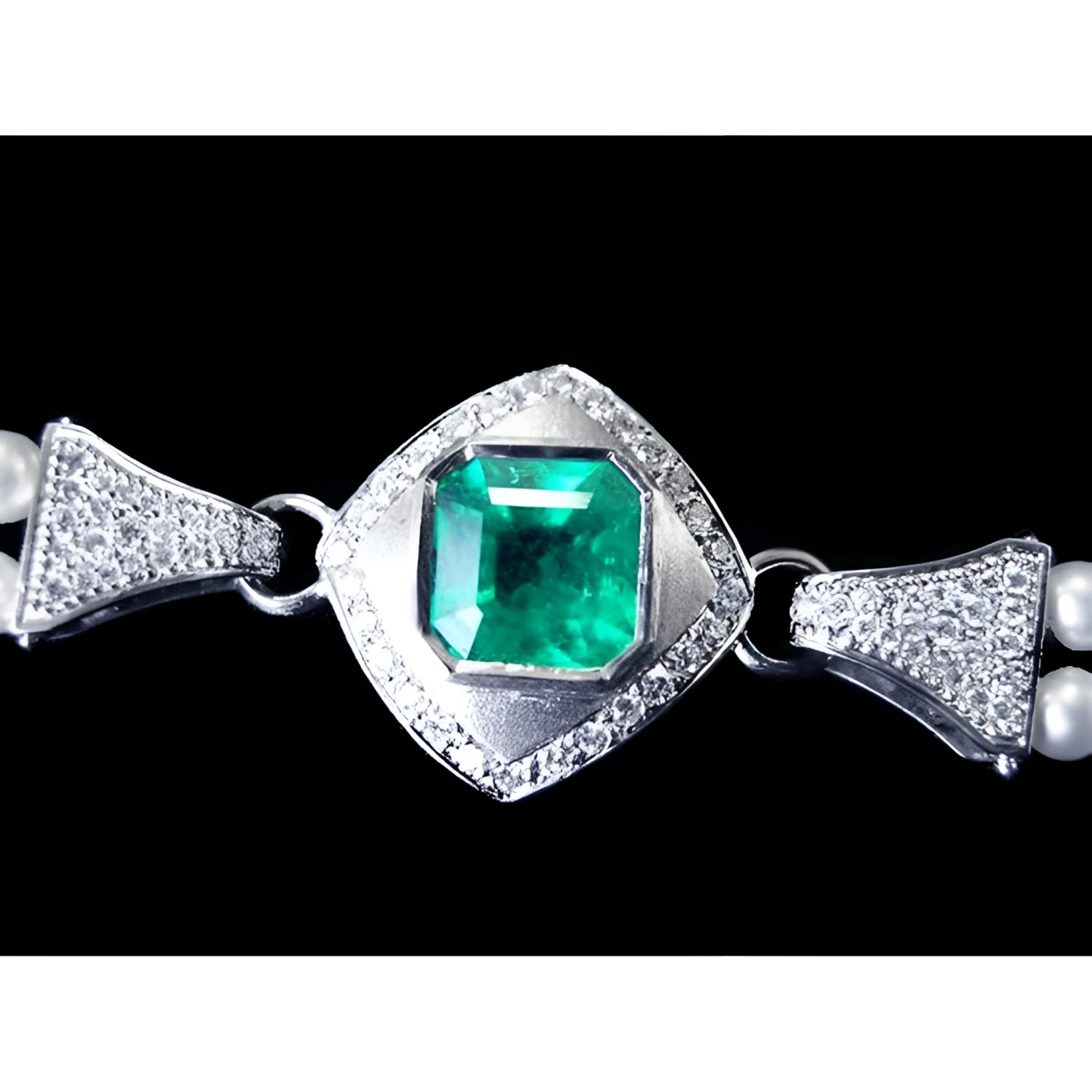18K white gold emerald and pearl bracelet with a bezel-set Colombian emerald and diamond accents.