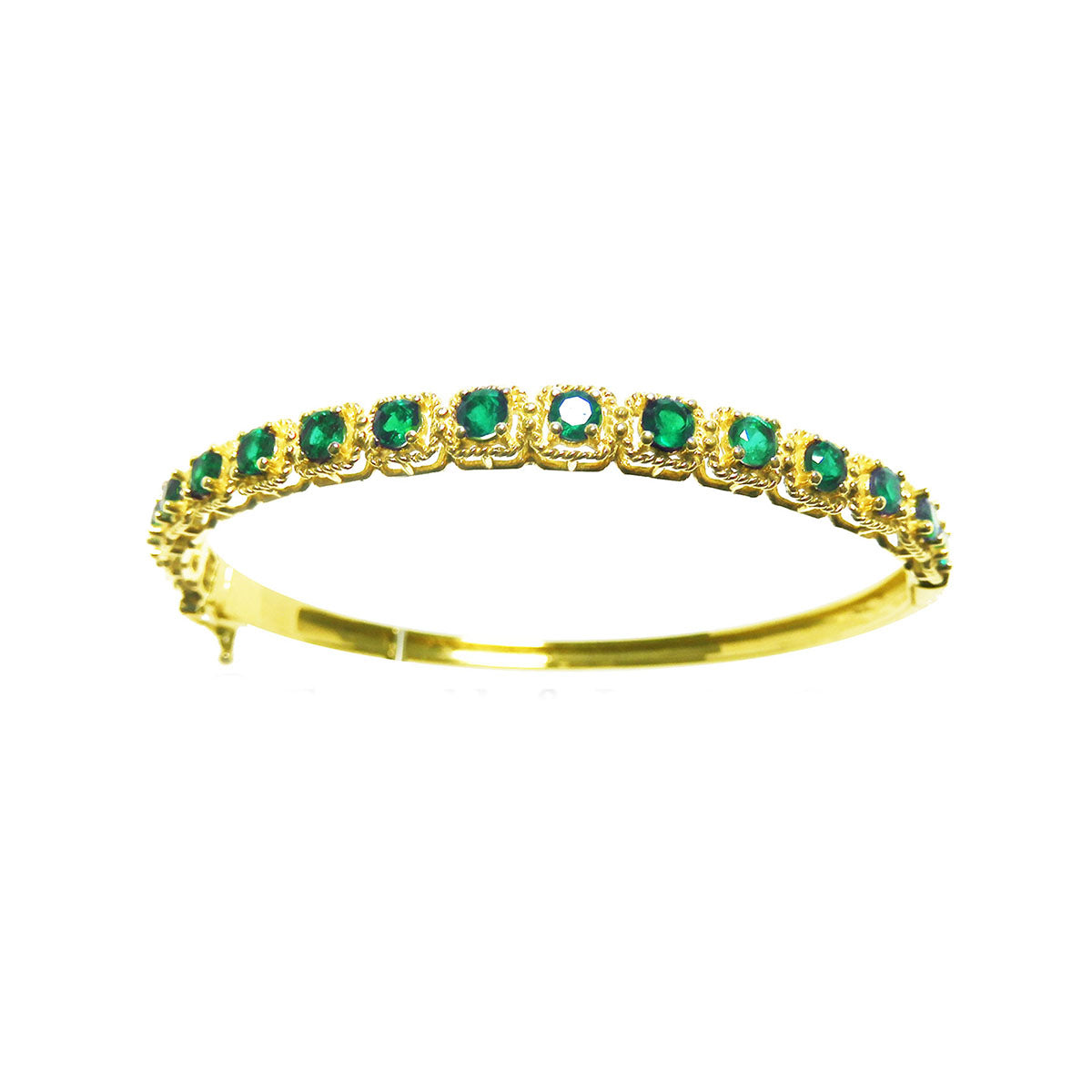 
the topside view of a gold bangle bracelet with round cut natural emeralds on a white background.