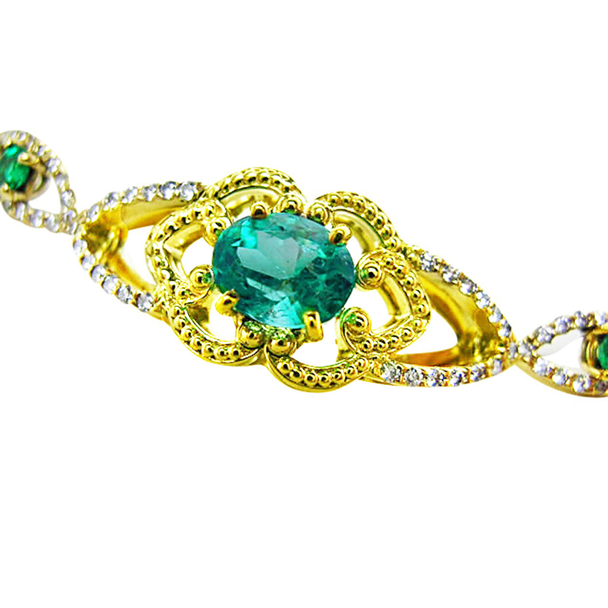 A topside view of a yellow gold bracelet with an oval cut natural emerald and accent diamonds.