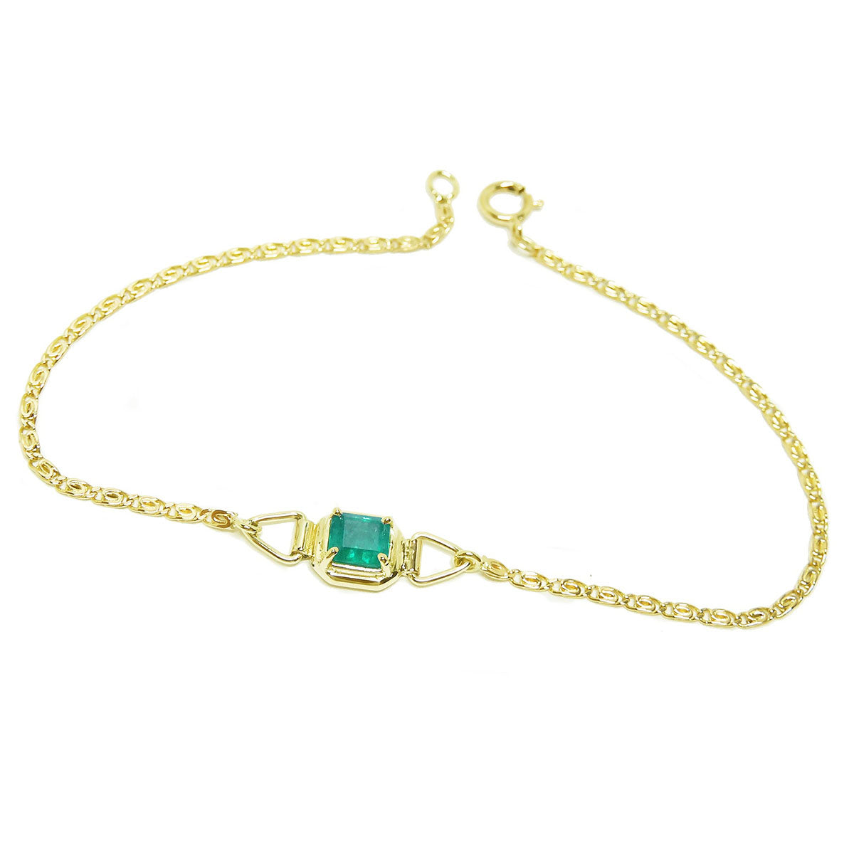 Gold bracelet with a solitaire Muzo colombian emerald on a white background.