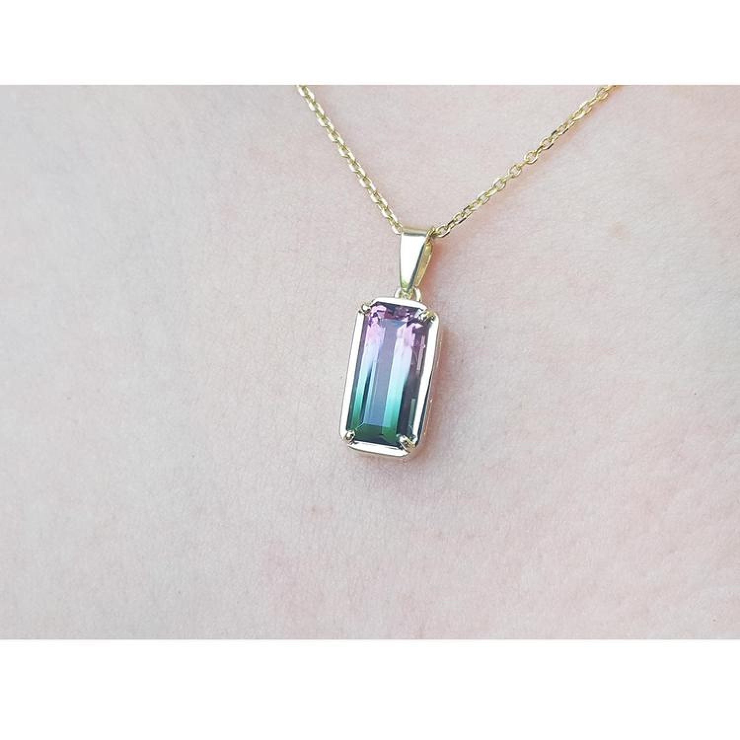 2.50 ct. watermelon tourmaline solitaire pendant with pink and blue-green hues in 14K yellow gold.