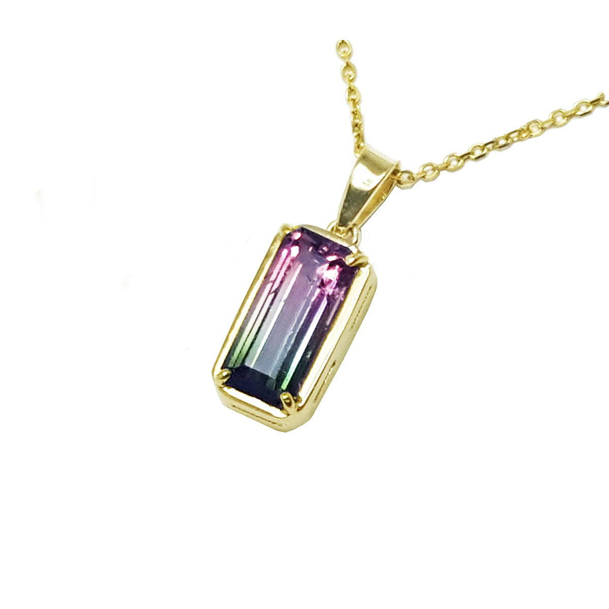Gold necklace with a multicolored tourmaline gemstone pendant on a left side profile view.