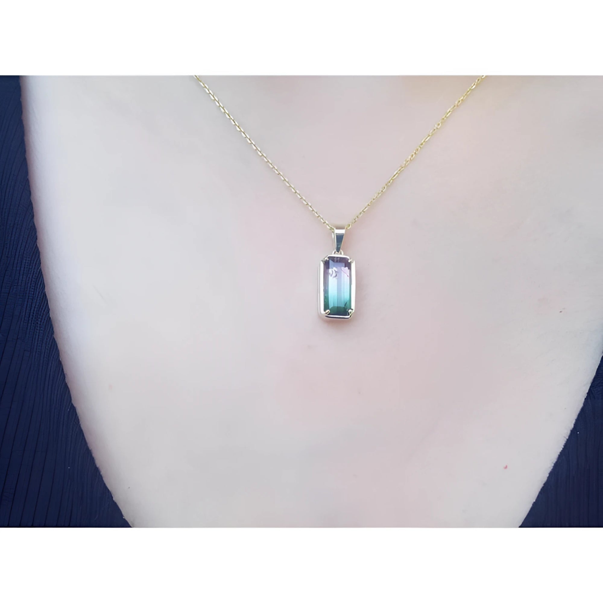 2.50 ct. watermelon tourmaline solitaire pendant necklace in 14K yellow gold, worn on a person.