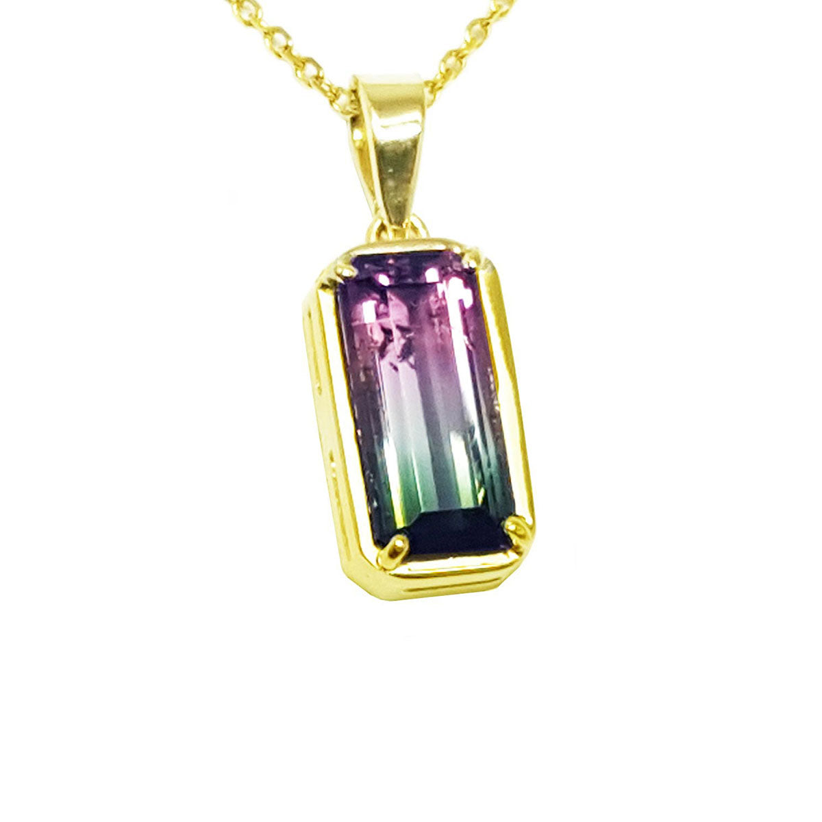 Gold pendant with a multicolored tourmaline gemstone on a white background.