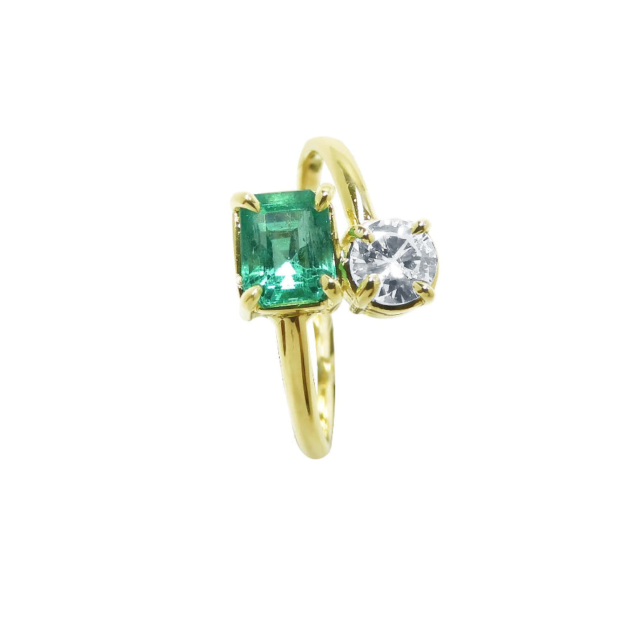 A 18k yellow gold You and Me ring design with a natural colombian emerald and diamond.