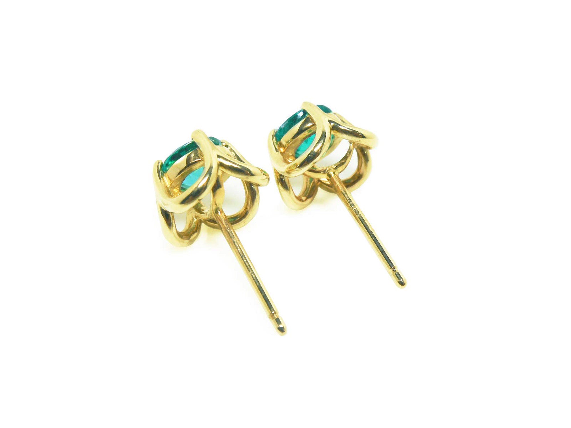 A pair of 14k gold tulip emerald stud earrings, underside profile view.