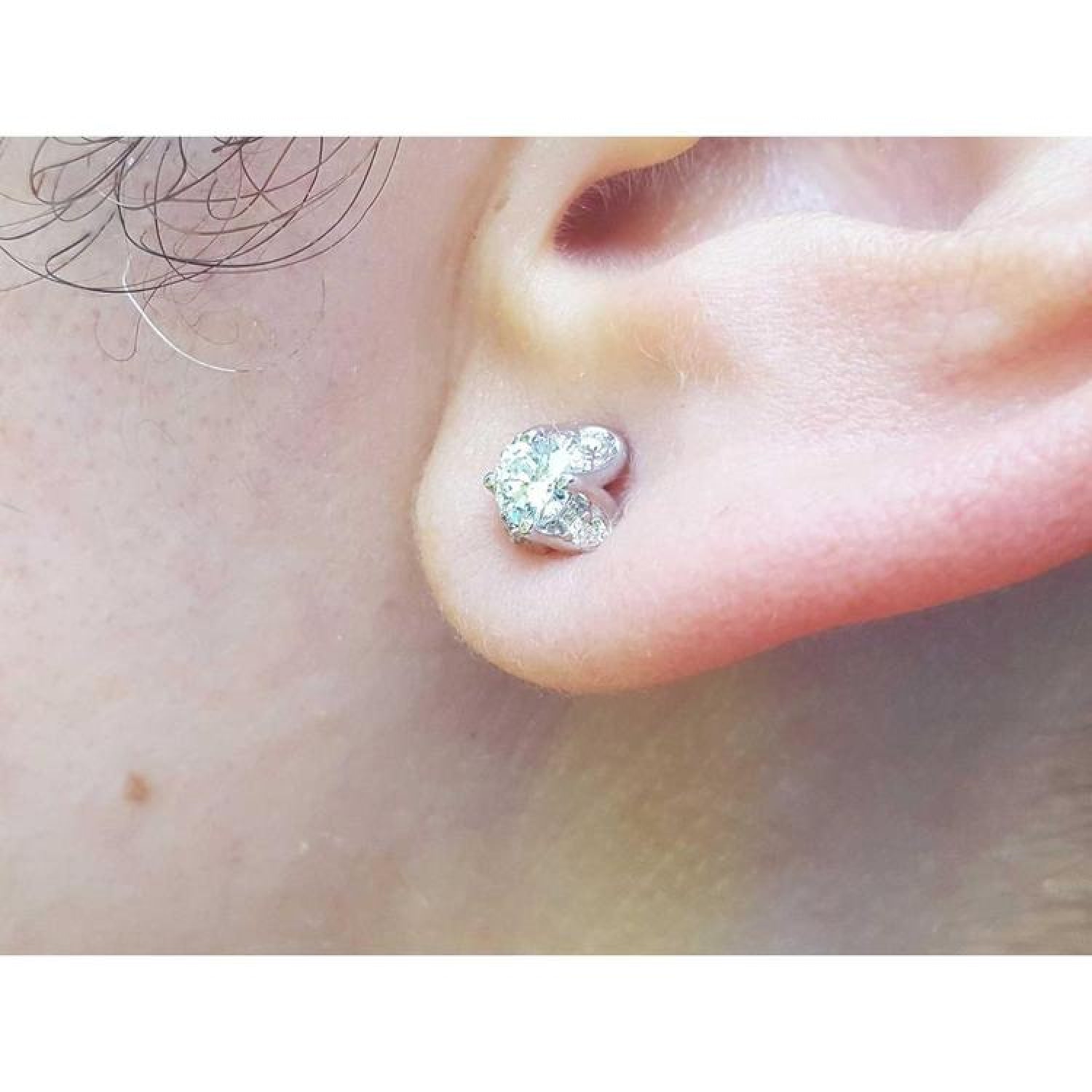 14K white gold tulip natural diamond stud earring with round-cut center and accent diamond petals.