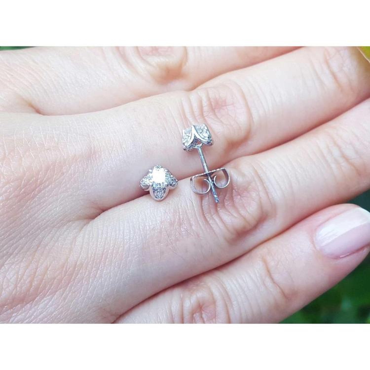 White gold tulip diamond stud earrings with round-cut diamonds and accent diamond petals.