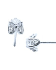 Two positions displaying a pair of white gold diamond stud earrings, tulip style, side profile view.