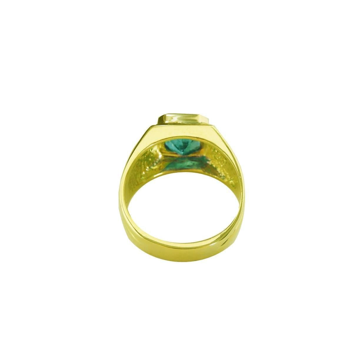 The underside view of a yellow gold women's emerald ring