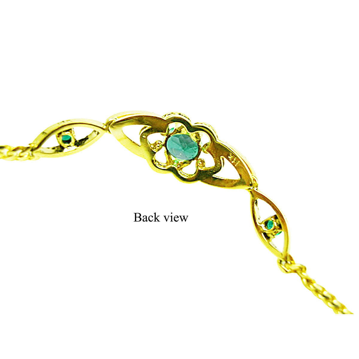 The downside view of a gold bracelet with genuine emeralds on a white background.