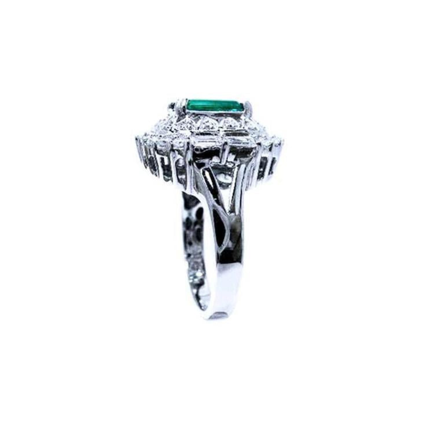 Vintage 2.40 ct Colombian emerald ring in 14K white gold with diamond accents.