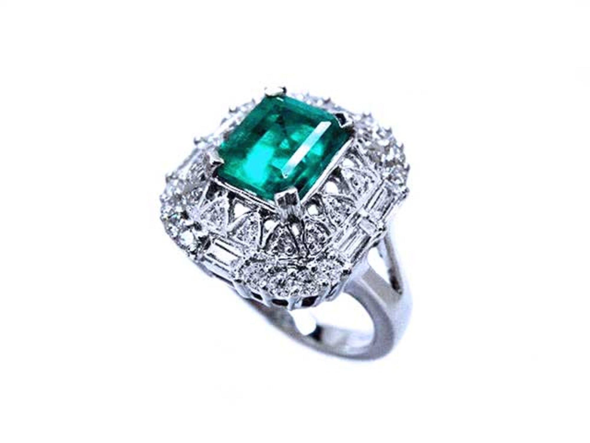 A unique vintage emerald ring with baguette and round diamonds, showing the topside and side profile.
