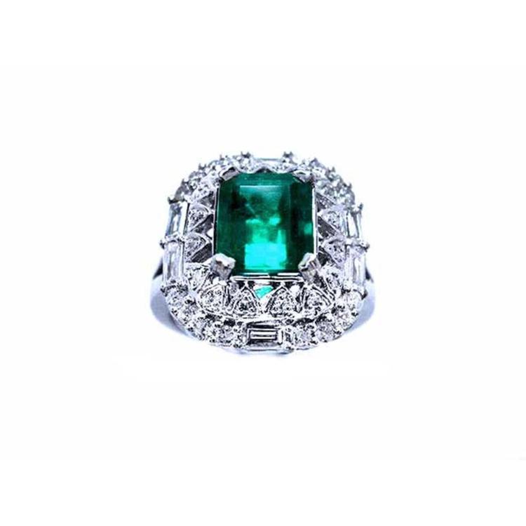 A vintage authentic Colombian emerald ring and accent diamonds in white gold.