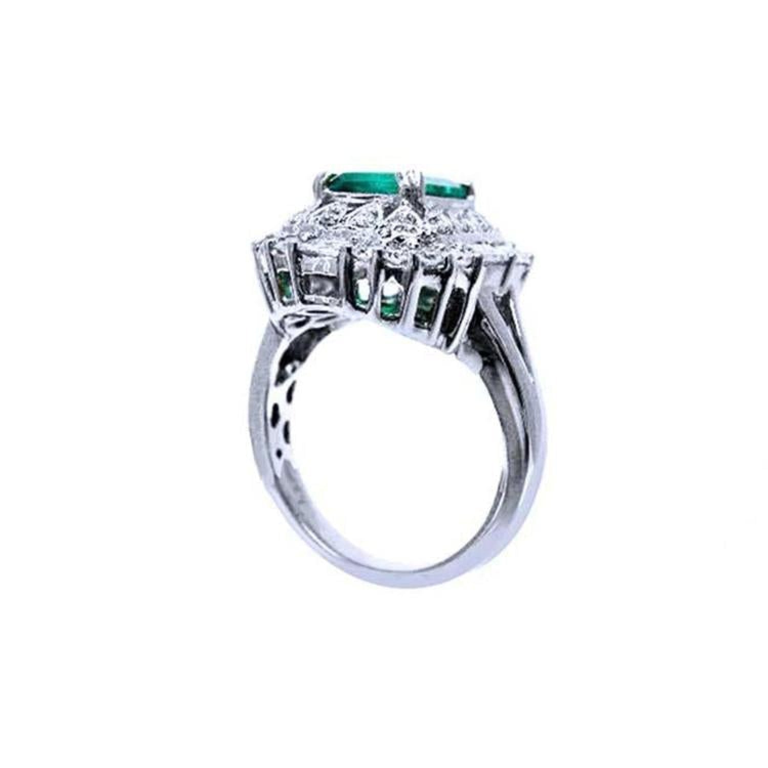 Vintage 14K white gold ring with a large green Colombian emerald and diamond accents.