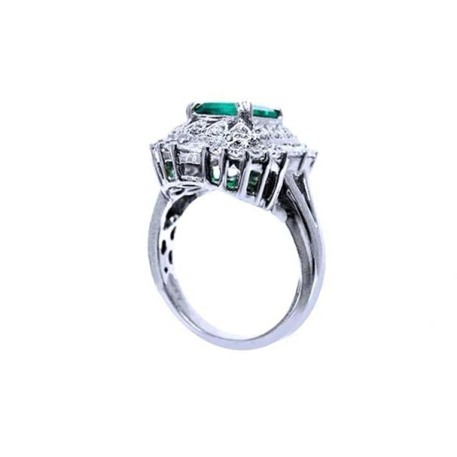 Vintage 14K white gold ring with a large green Colombian emerald and diamond accents.