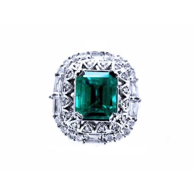 This vintage-style Colombian emerald ring features a square emerald cut, encircled by sparkling diamonds, and crafted from 14k white gold.