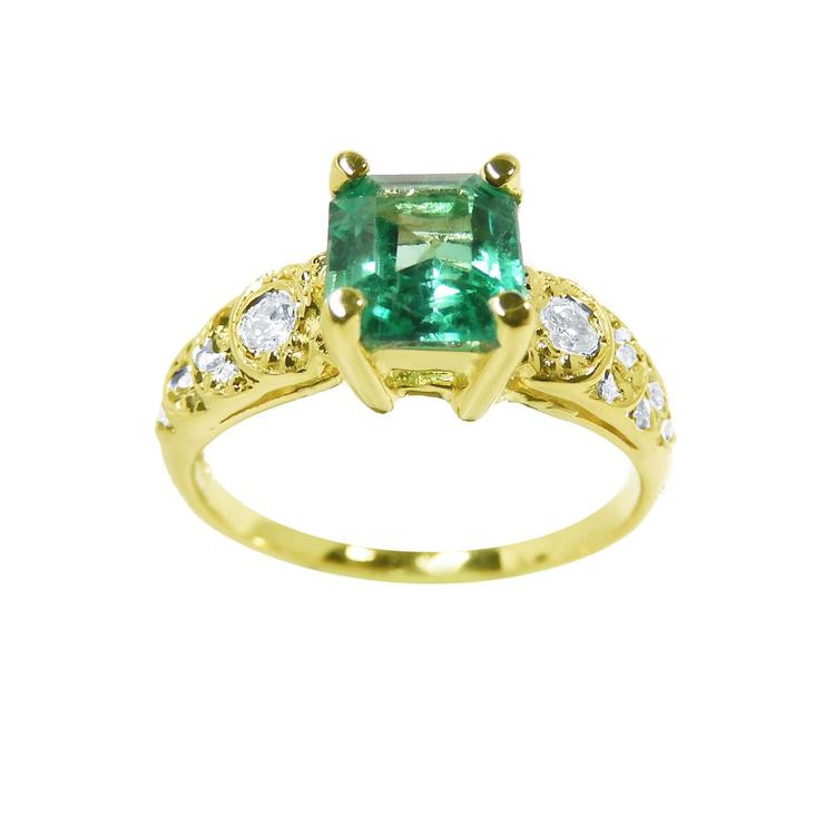 A vintage natural colombian emerald ring for women with accent diamonds crafted in 14k yellow gold.