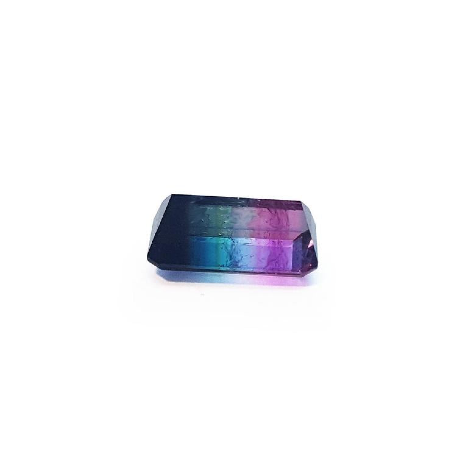 Rectangular emerald cut watermelon tourmaline with vibrant red-orange, bluish-green, and purple hues.