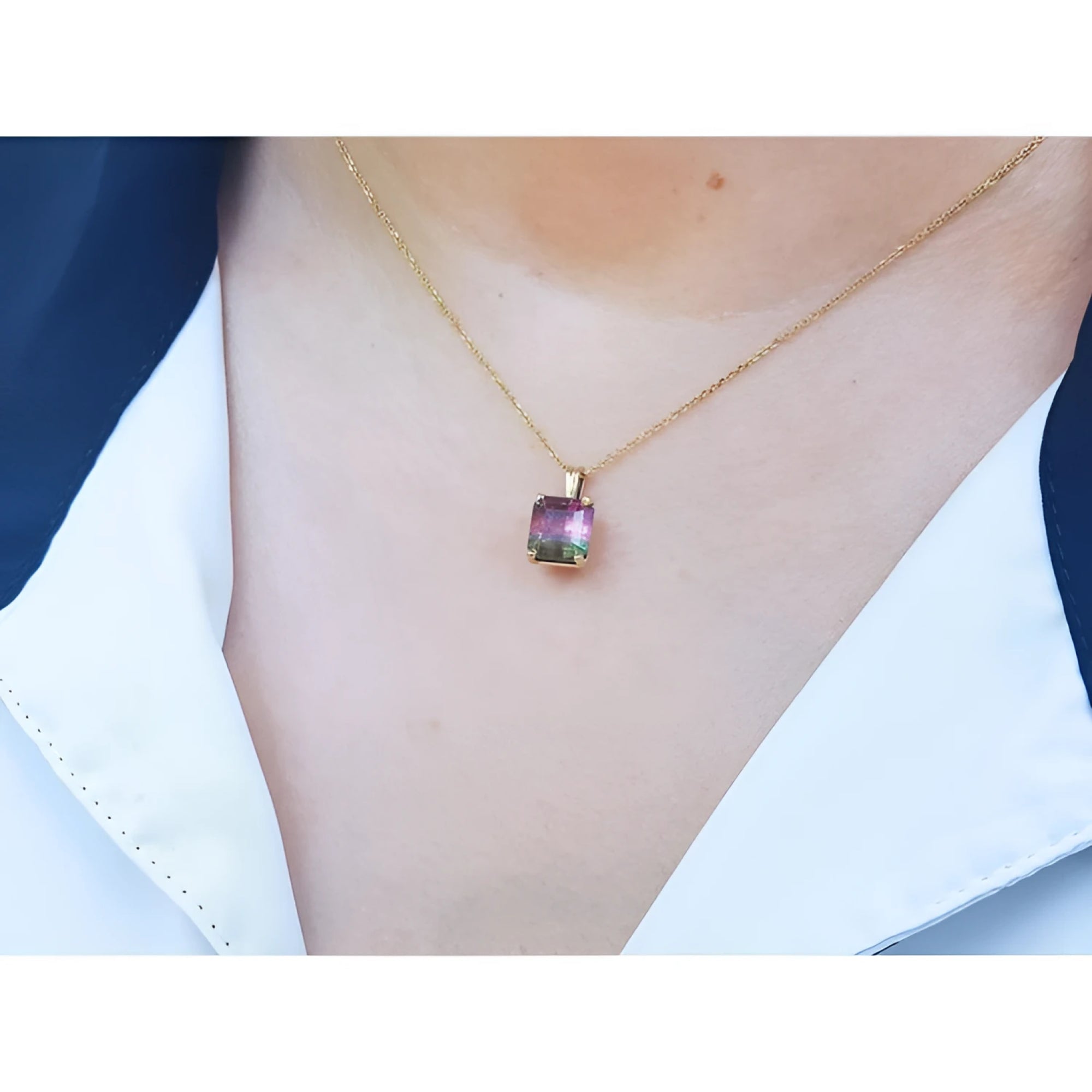 Brazilian bicolor tourmaline watermelon solitaire pendant in 14K yellow gold on a model.
