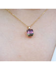 Necklace with a colorful tourmaline pendant on a person's neck.