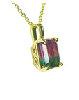 Gold necklace with a multicolored tourmaline gemstone pendant on a white background.
