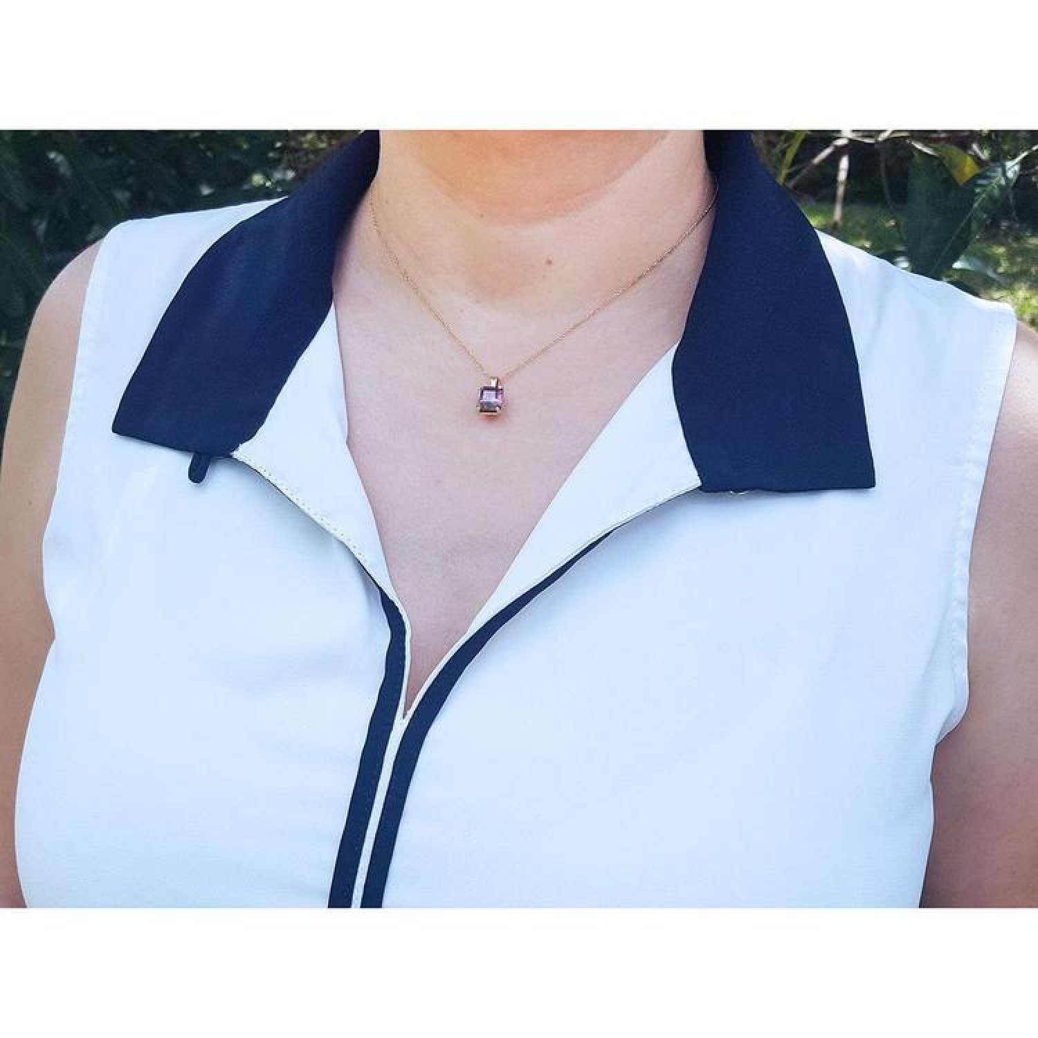 Brazilian tourmaline watermelon solitaire pendant in 14K yellow gold on a woman's neck.