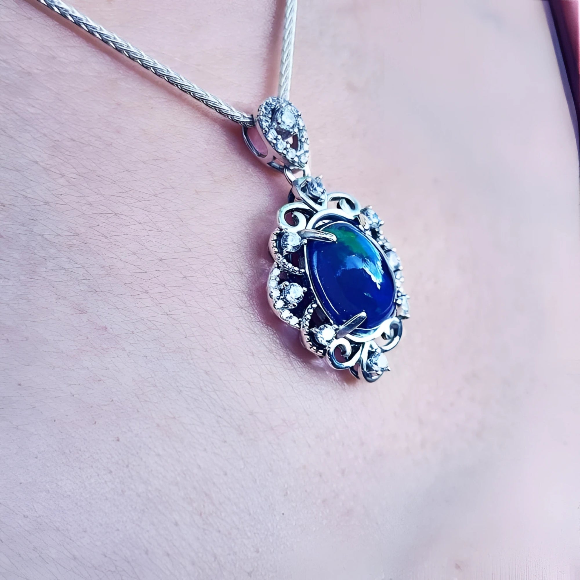 Multicolor Welo Ethiopian black opal pendant in ornate sterling silver with CZ accents.