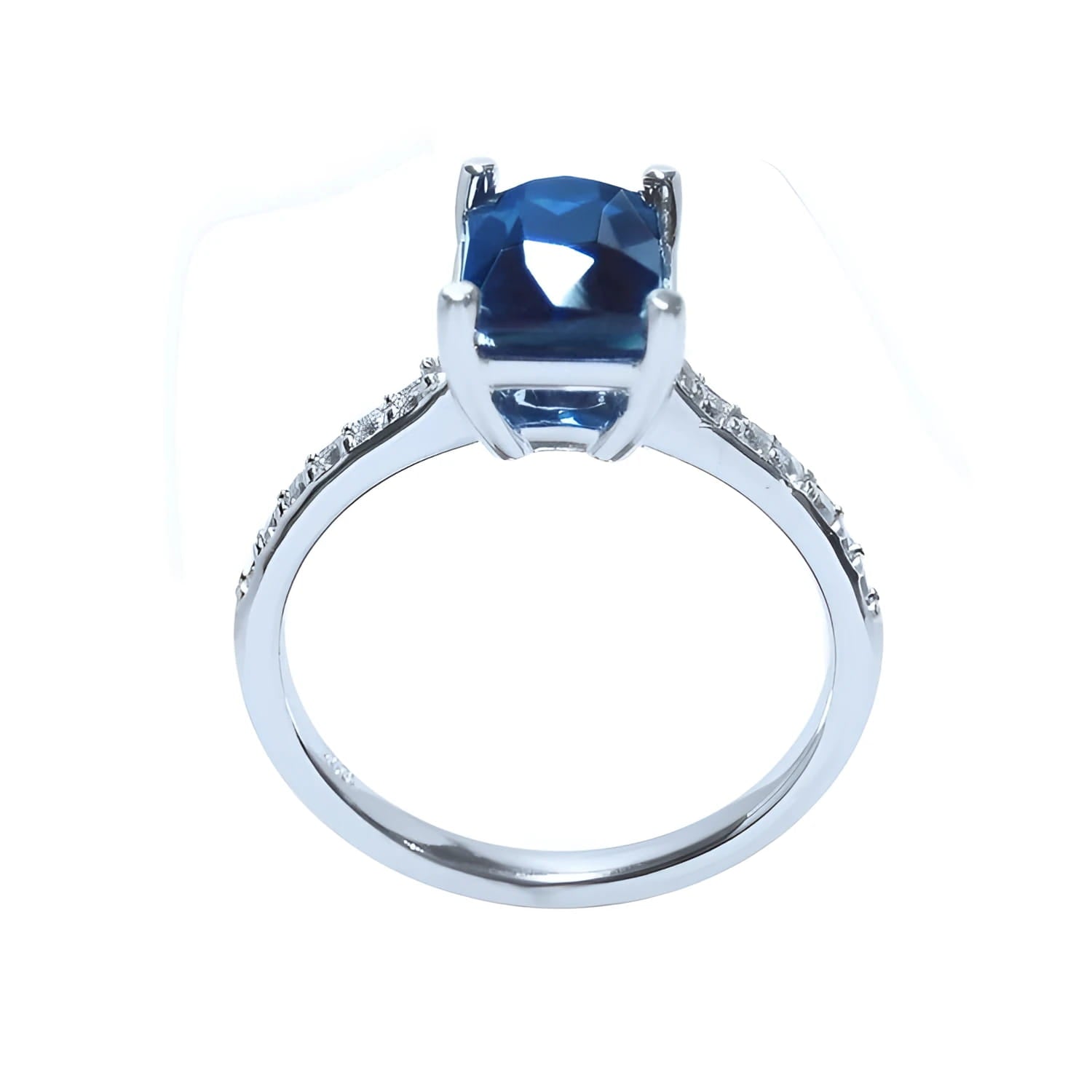 18K white gold ring with a radiant-cut deep blue sapphire and diamond accents.