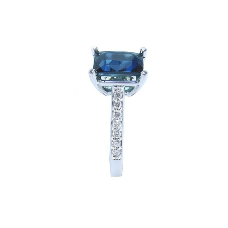 18K white gold ring with a radiant-cut blue sapphire and diamond accents.