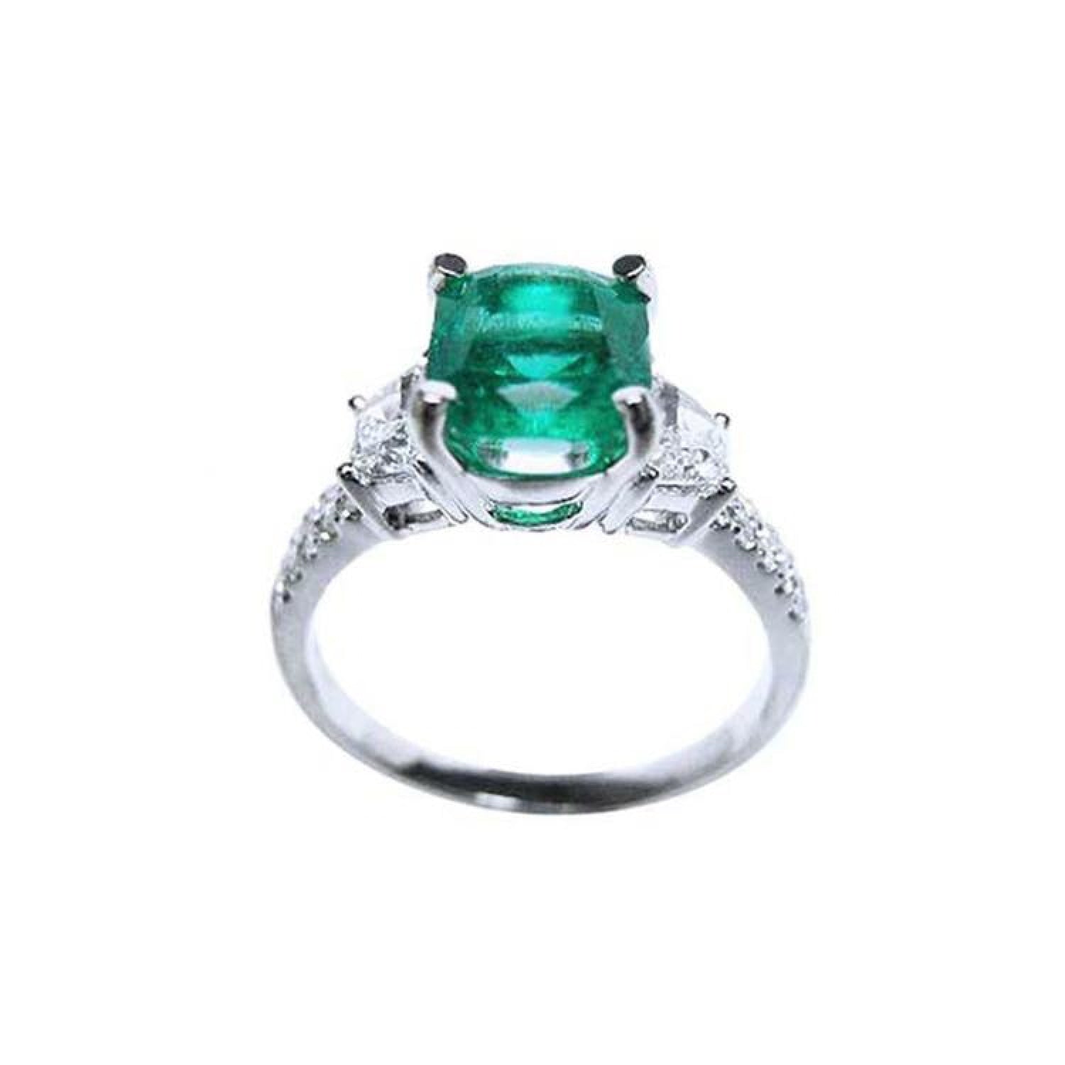 1.90 carat cushion cut emerald and trapezoid diamond ring in 18K white gold.