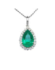 18K white gold pear-shaped emerald pendant with a halo of natural diamonds on a delicate chain.