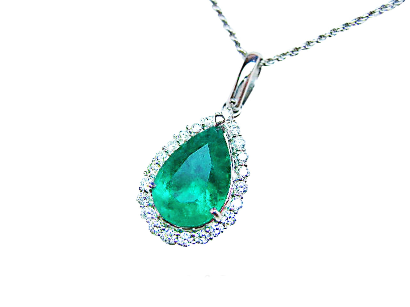 Emerald teardrop pendant with diamond halo on a white background