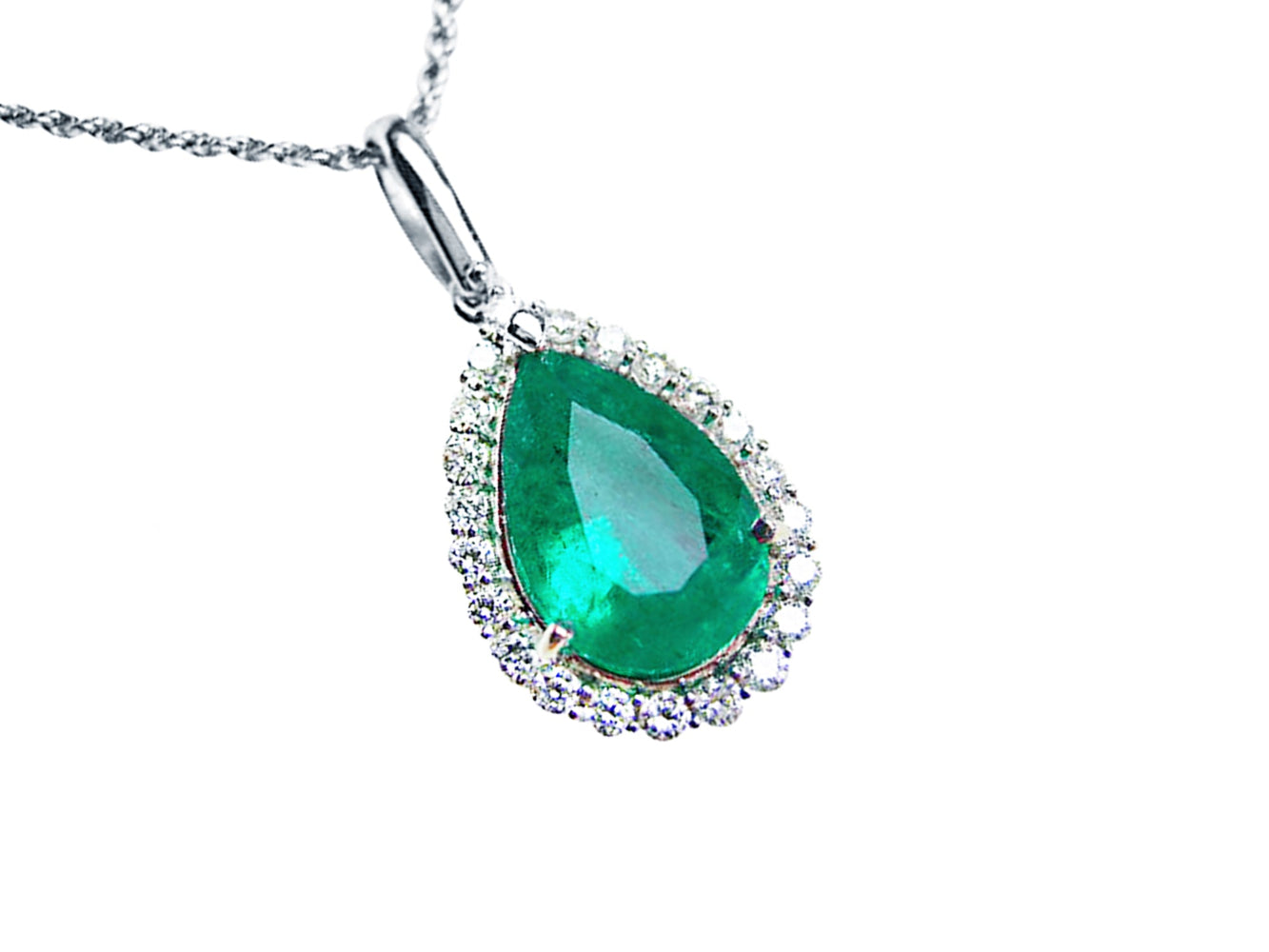 Emerald green teardrop pendant with diamond accents on a right-side position displaying topside view