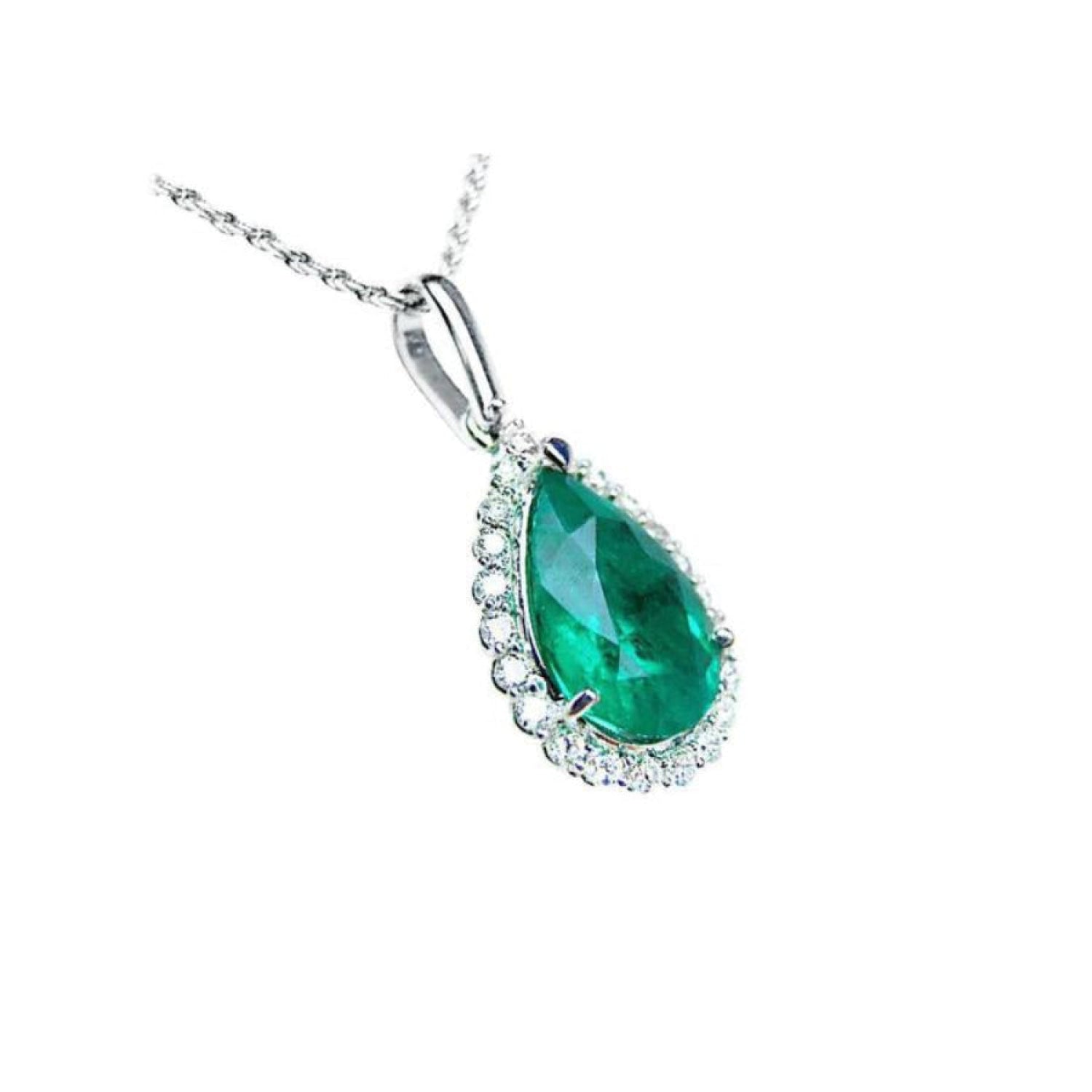 18K white gold pear-shaped emerald pendant with a halo of natural diamonds on a delicate chain.