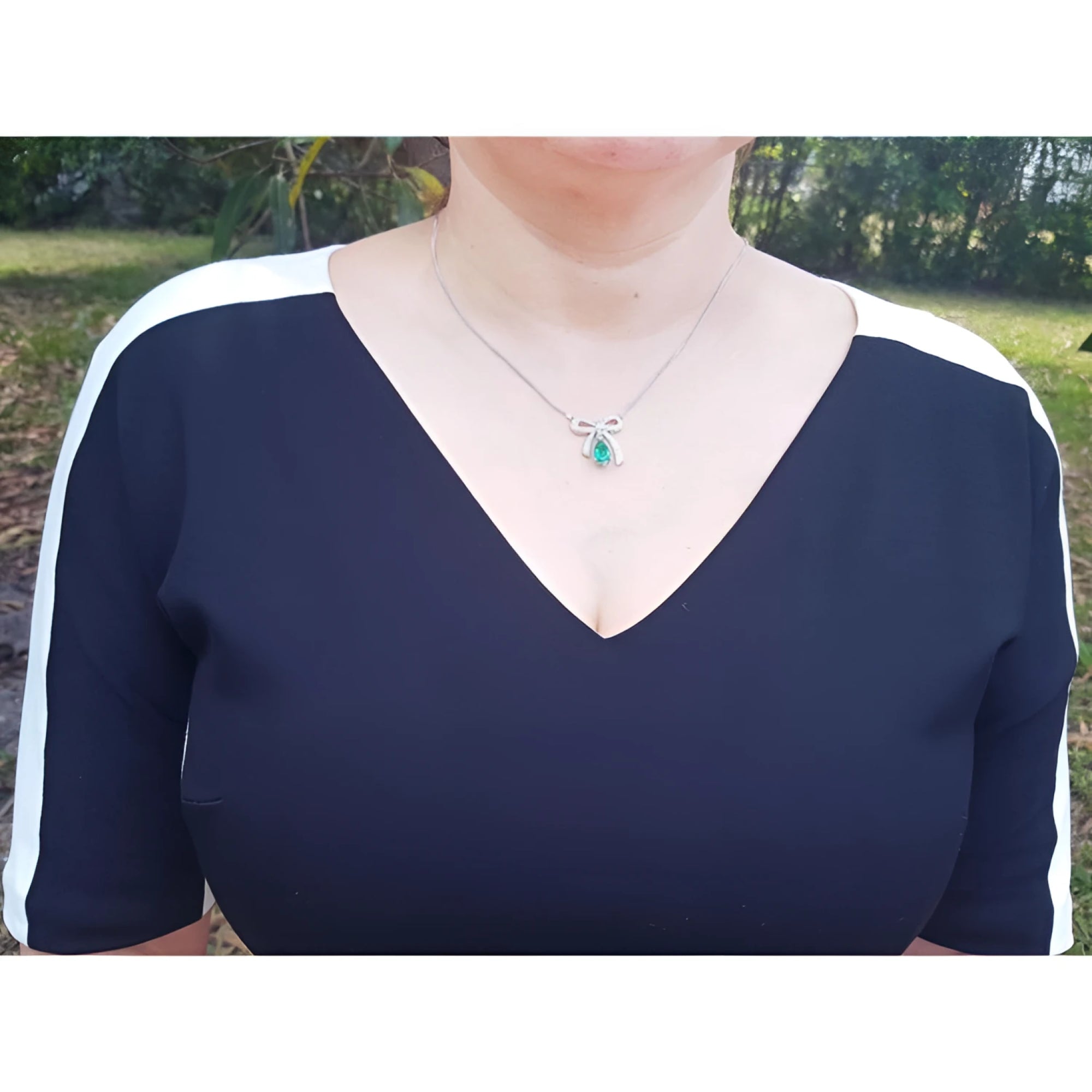 Emerald bow tie necklace, pear-shaped 1.28 ct. deep green emerald, 18K white gold.