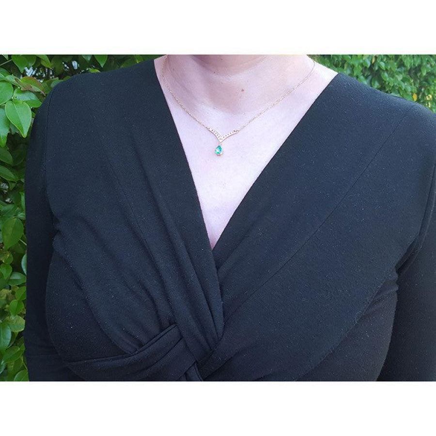 1.01 carat pear cut emerald necklace with accent diamonds on a 14K gold V chevron design.
