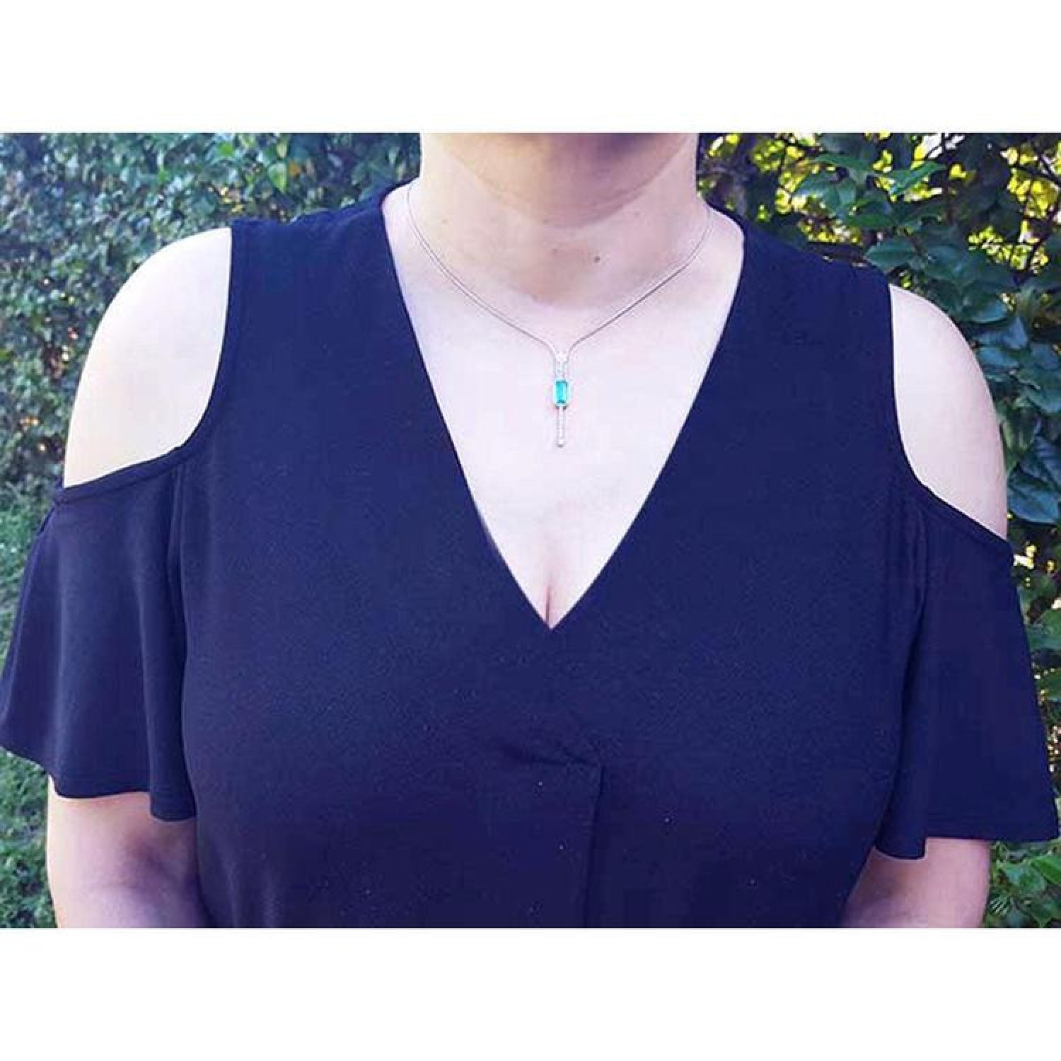 Women's 14K white gold necklace with an elongated Colombian emerald pendant and diamond accents.