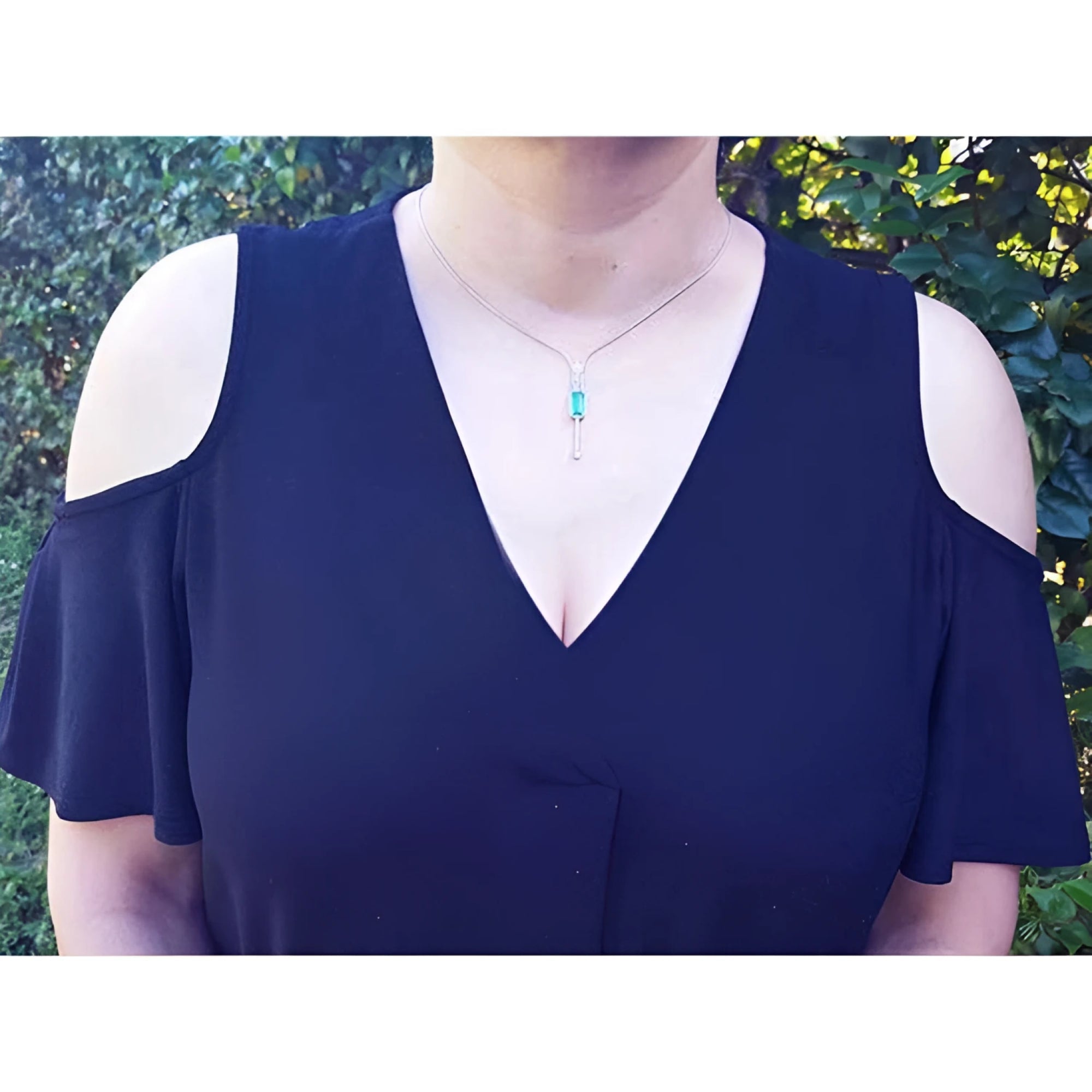 Women's 14K white gold necklace with an elongated Colombian emerald pendant and diamond accents.