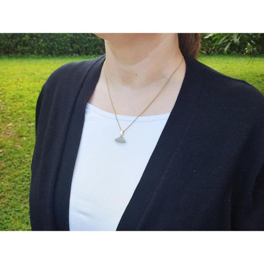 Ethiopian Welo opal pendant necklace with full play of colors, dangling from a 14k gold bail-stem.