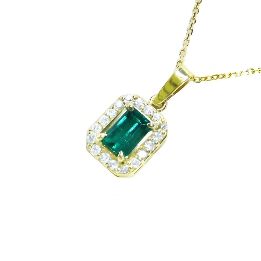 18k yellow gold pendant with a vibrant emerald-cut Colombian emerald and diamond halo.