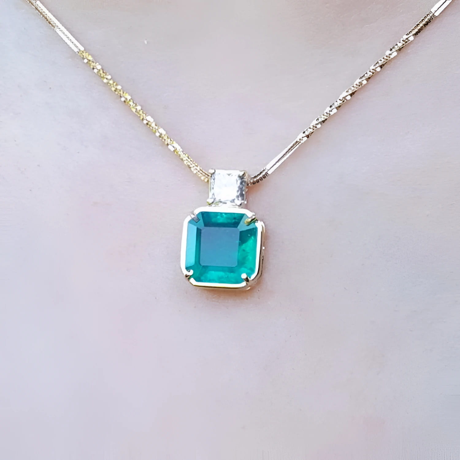 18k yellow gold necklace with an Asscher cut colombian emerald gemstone pendant top accent diamond.