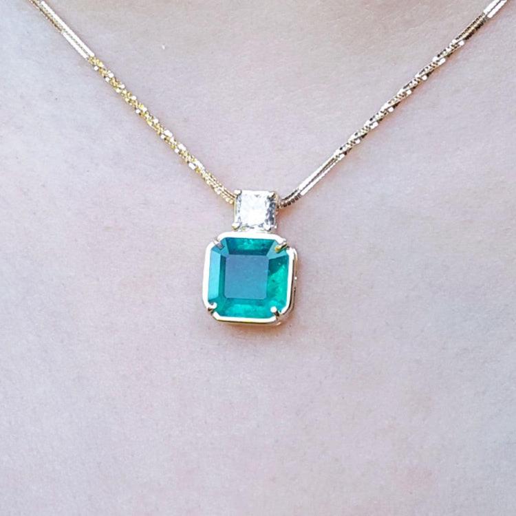 18k yellow gold necklace with an Asscher cut colombian emerald gemstone pendant top accent diamond.