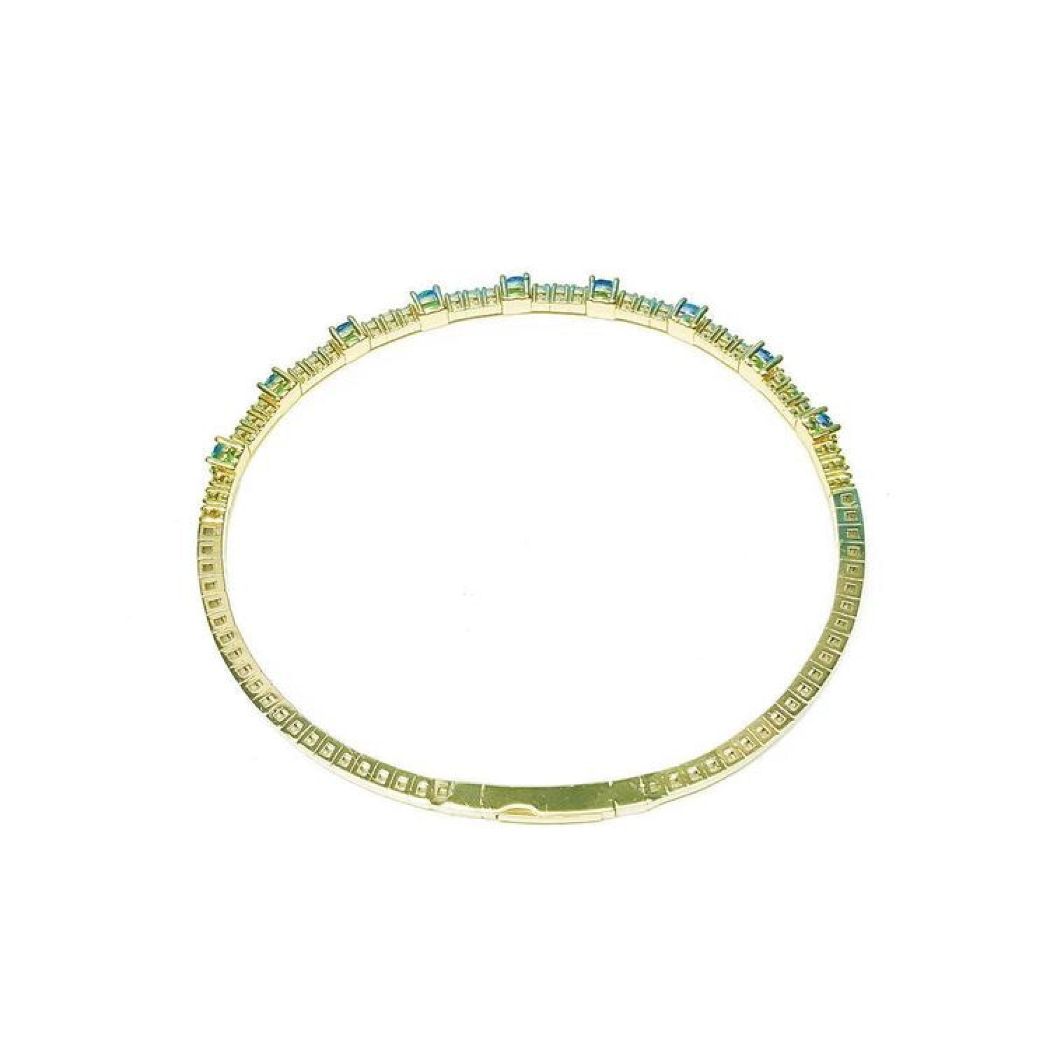 Flexible 14K yellow gold bangle bracelet with square-cut emeralds and accent diamonds.